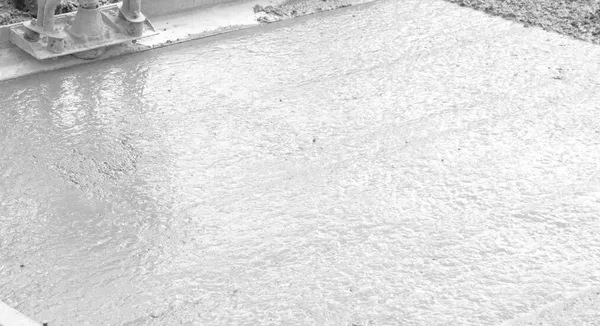 Close-up of freshly poured and levelled concrete surface, black and white photograph